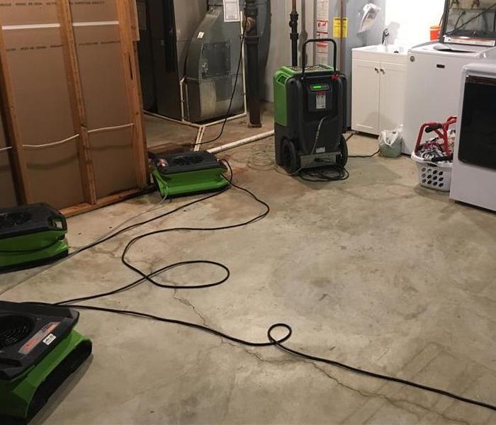 Five air movers on the concrete floor.