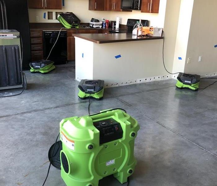 Kitchen with concrete floors and green air movers.