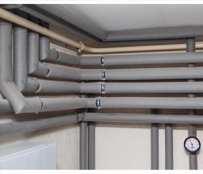 The pipelines in the insulation and pressure gauges flow and return pipes in the boiler room of a private house household