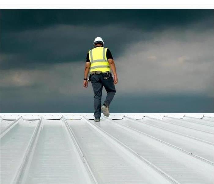 Construction engineer uniform safety dress safety inspection of metal roofing for industrial roofing concept with copy space